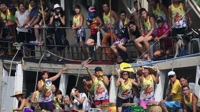 Fans play drums to support their team during the dragon boat races in Hong Kong on Saturday. Kin Cheung / AP