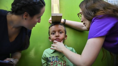 A volunteer of the "Aid and Freedom Coalition" movement takes a child's measurements during a medical attention camp in the Macarao neighbourhood in Caracas, Venezuela. AFP