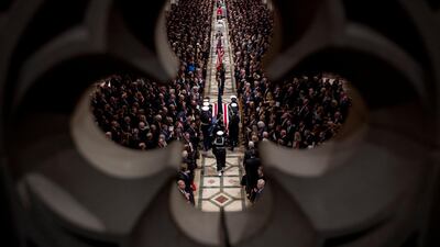 The flag-draped casket of former President George H.W. Bush is carried by a military honor guard during a State Funeral at the National Cathedral in Washington, DC. Reuters