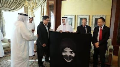 Sheikh Nahyan bin Mubarak, Minister for Culture, Youth and Community Development, accepts a gift from the Jashanmal family. Also in attendance was Pablo Kang, right, the Australian ambassador. Delores Johnson / The National