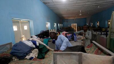 People inspect belongings of the missing pupils. AP Photo