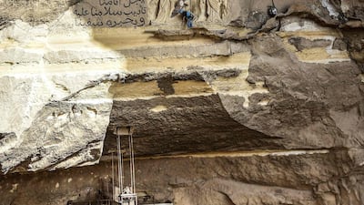 Polish artist Mario (top), sculptor of St. Simon the Tanner Monastery complex, works on a scene relief depicting the Crucifixion of Jesus Christ and a verse in Arabic from the Biblical Book of Isaiah reading "he was wounded for our transgressions, he was bruised for our iniquities, the chastisement of our peace was upon him; and with his stripes we are healed", at the church in the Egyptian capital Cairo's eastern hillside Mokattam district, . Mario spent more than two decades carving the rugged insides of the seven cave churches and chapels of the rock-hewn St. Simon Monastery and church complex atop Cairo's Mokattam hills, with designs inspired by biblical stories. It was all done to fulfil the wishes of the church's parish priest who met Mario in the early 1990s in Cairo. The Polish artist, who had arrived in Egypt earlier on an educational mission, was then looking for an opportunity to serve God at the monastery. AFP