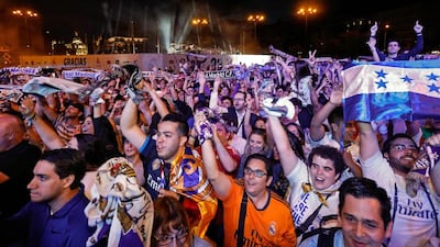 Real Madrid fans celebrate the team’s win on Plaza Cibeles in Madrid on May 21, 2017. Oscar del Pozo / AFP