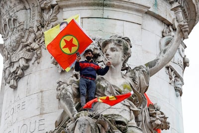 A man holds a PKK flag at a protest in Paris on Saturday. Reuters