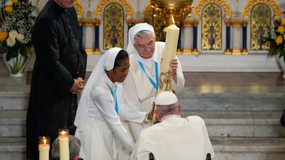 The Pope blesses a candle during a Marian prayer with the diocesan clergy at the Notre-Dame de la Garde basilica in Marseille. AP
