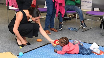 The Duchess of Sussex plays with 15-month-old Asivile as she visits M2M during her royal tour of South Africa. Getty Images