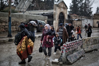 Residents of Sheikh Maqsoud in Aleppo leave the area through a humanitarian corridor. EPA
