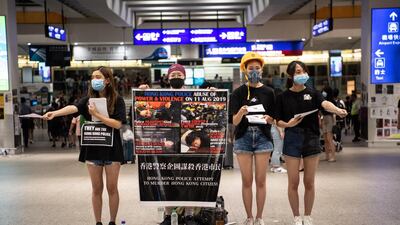 Protesters hand out flyers during a sit-in against police violence in Hong Kong Chek Lap Kok International Airport. EPA