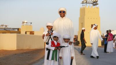 A family dresses up for National Day at the Sheikh Zayed Heritage Festival. Sarah Dea / The National