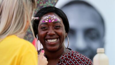 A reveller has some glitter applied to her face at the Expo 2020 countdown event.