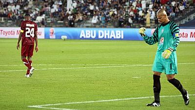 Al Wahda’s Abdulraheem Jumaa walks off after missing his penalty kick, while Miguel Caleroi, the Pachuca goalkeeper, celebrates.