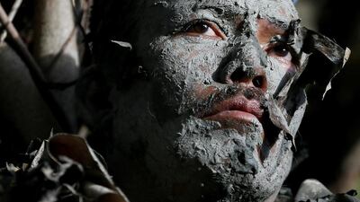 A villager, donning capes mostly of dried banana leaves and covered in mud, attends a mass during the ‘Taong Putik’ or ‘mud people’ festival in an annual ritual to venerate their patron saint, John the Baptist at Bibiclat, Aliaga township, Nueva Ecija province in northern Philippines. Bullit Marquez / AP Photo