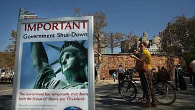 A sign informs visitors that the Statue of Liberty is closed due to the government shutdown in Battery Park. Spencer Platt/Getty Images/AFP