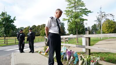 Chief Supt Trevor Lawry looks at some the floral tributes laid in memory of the teacher.