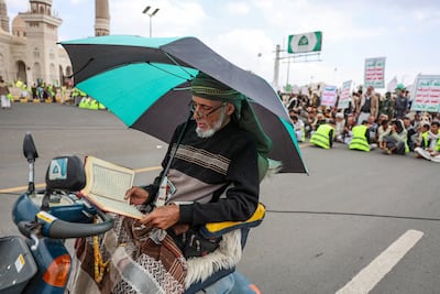 A man reads the Quran during a rally to mark Al Quds Day in Sanaa. Reuters