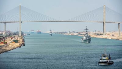 The guided-missile cruiser USS Monterey (CG 61), left, and the guided-missile destroyer USS Thomas Hudner (DDG 116) sail behind the aircraft carrier USS Dwight D. Eisenhower (CVN 69) during a Suez Canal transit, in this picture taken April 2, 2021 and released by U.S. Navy. Reuters