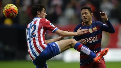 Sporting Gijon’s midfielder Pablo Perez Rodriguez (L) vies with Barcelona’s Brazilian defender Adriano during the Spanish league football match Real Sporting de Gijon vs FC Barcelona at El Molinon stadium in Gijonon 2016. AFP PHOTO / MIGUEL RIOPA