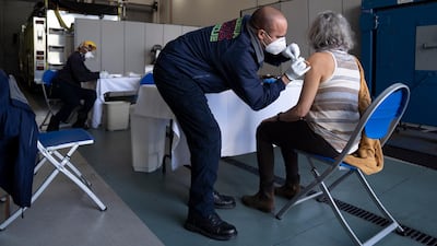 Firefighter/paramedic John Kostyo Jr., administers a Covid-19 vaccination at the Tequesta Fire Department in Tequesta, Florida. AP Photo