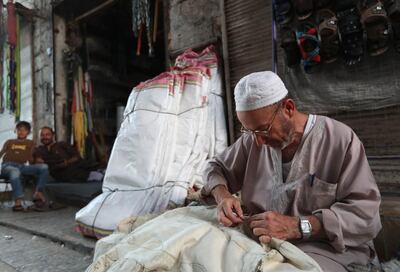 An elderly Syrian weaves a quilt in the rebel-held town of Maaret al-Numan in the north of Idlib. AFP