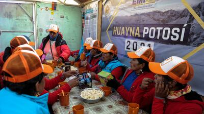 The Climbing Cholitas of Bolivia Warmis rest and have something to eat at a shelter before beginning their ascent of Huayna Potosi.