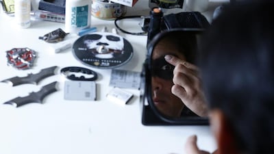 Chibatman puts on make-up as he dresses up before going on the road on his Chibatpod.