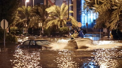 People having fun with a boat on the flooded main road of the Daeya area of Kuwait city. AFP