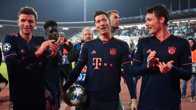 Robert Lewandowski, centre, celebrates with Thomas Muller, left, and Benjamin Pavard after the match against Red Star. AFP