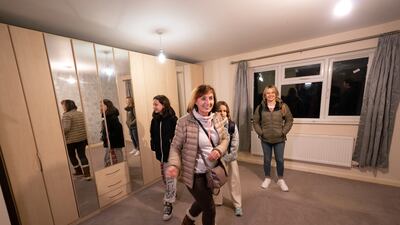 Iryna Starkova and her family look around one of the bedrooms.