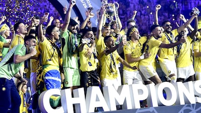 Al Nassr players celebrate with the Saudi Pro League trophy after beating Damac 4-1 at Al Awwal Park. EPA