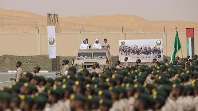Sheikh Hazza bin Zayed Al Nahyan, Vice Chairman of the Abu Dhabi Executive Council, Sheikh Hamdan bin Mohammed, Crown Prince of Dubai, and Lt Gen Hamad Al Romaithi, Chief of Staff UAE Armed Forces, inspect National Service military personnel during a ceremony marking the 40th anniversary of the Armed Forces unification, and the graduation ceremony for the 5th batch of National Service personnel, at the Seeh Al Hama camp. Ryan Carter / Crown Prince Court - Abu Dhabi
