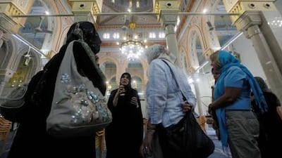 Tourists gather at the Jumeirah Mosque in Dubai. An influx of expatriates has given the UAE a multicultural environment.