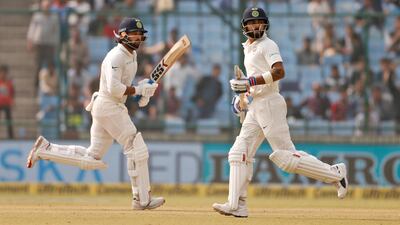 Virat Kohli, right, and Murali Vijay put on a 283-run stand against Sri Lanka at Delhi on Saturday. Altaf Qadri / AP Photo