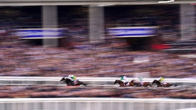 Brazil, ridden by jockey Mark Walsh, speeds past the crowds on its way to winning the Boodles Juvenile Handicap Hurdle. PA