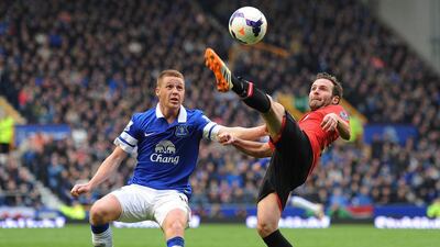 Everton player James McCarthy, left, in action against Manchester United player Juan Mata during their Premier League match. Peter Powell / EPA / April 20, 2014