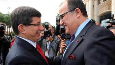 Turkish Foreign minister Ahmet Davutoglu shakes hands with Fassi Fihr, right, in Rabat on Tuesday.