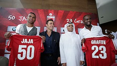 Fabio Cannavaro, second left, and Ahmed Khalifa Hammad, second right, stand alongside Al Ahli's two new signings, Jakson Avelino Coelho and Grafite, at their unveiling at the Burj Khalifa in Dubai.