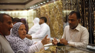 Pilgrims shop at a jewellery store ahead of this year's Haj in the holy city of Mecca. Ibraheem Abu Mustafa / Reuters