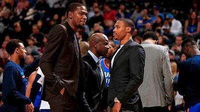 Kevin Durant, left, and Russell Westbrook of the Oklahoma City Thunder look on from the bench as they sat out the game against the Denver Nuggets at Pepsi Center on November 19, 2014 in Denver, Colorado. The Nuggets defeated the Thunder 107-100. Doug Pensinger/Getty Images/AFP