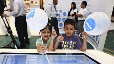 Visitors to the Humanitarian Day exhibit at Dubai Mall learnt about the work of aid teams through interactive video screens. Sarah Dea / The National