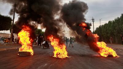 Anti-government protesters set fires and close a street during a demonstration in Baghdad. AP Photo