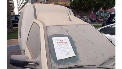 A notice from Abu Dhabi Municipality warns the owner of this dusty vehicle that it will be towed away if it is not removed.