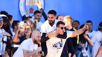 Ilkay Gundogan of Manchester City celebrates on stage with backroom staf. Getty Images