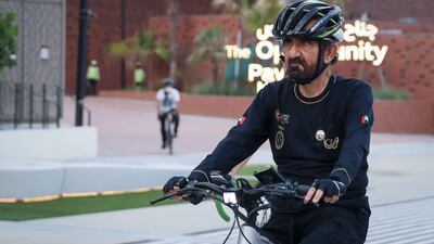 Sheikh Mohammed bin Rashid, UAE Vice President and Ruler of Dubai, takes a bike tour of the Expo 2020 Dubai site. The Opportunity Pavilion is in the background. Photo: Dubai Media Office