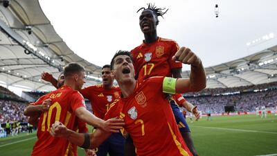 Dani Olmo of Spain, left, celebrates with teammates after scoring the opening goal. EPA