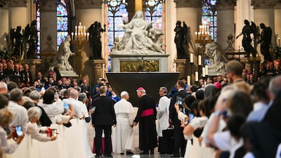 Pope Leo is welcomed by the Archbishop of Paris, Laurent Ulrich, on arrival at Notre-Dame Cathedral. AFP