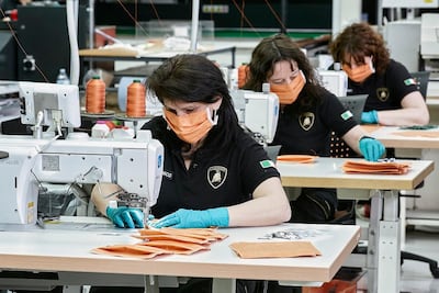 Upholstery workers at Lamborghini producing surgical masks for a hospital in Italy