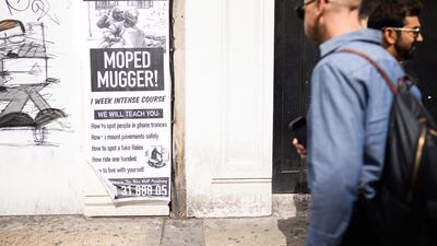 A satirical piece of street art advertises lessons in how to become a "Moped Mugger" following a series of snatches. (Getty Images)
