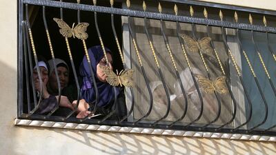 Women watch the funeral of Mohammed Hamayel from a home in the West Bank village of Beita. AFP