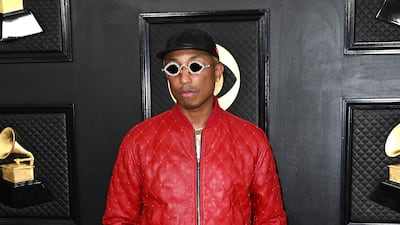 Pharrell Williams wears a studded red leather bomber jacket with matching trousers by Ernest W Baker. AFP