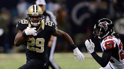New Orleans Saints' Chris Ivory breaks past Atlanta's Asante Samuel on his way to a touchdown.